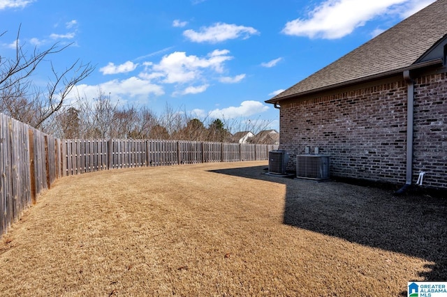 view of yard with a fenced backyard and cooling unit