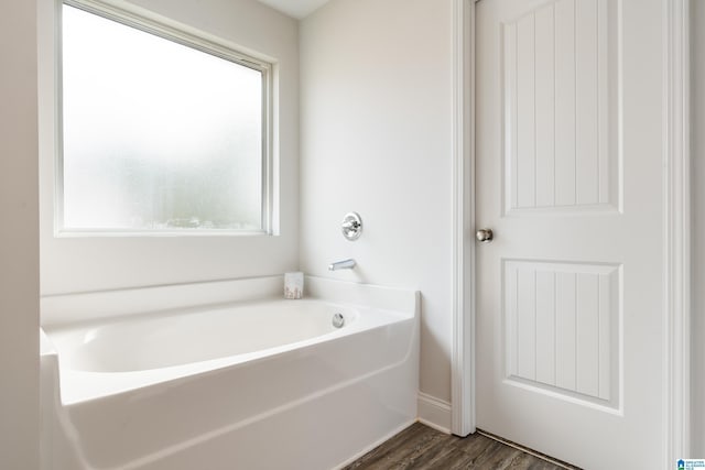 full bathroom with a garden tub and wood finished floors