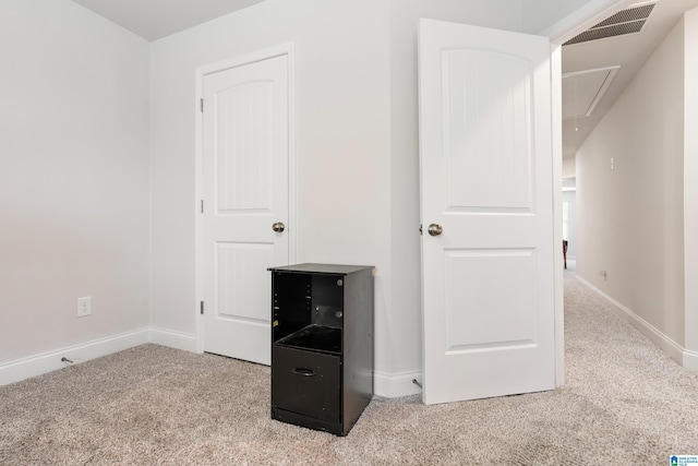 interior space with attic access, carpet flooring, baseboards, and visible vents