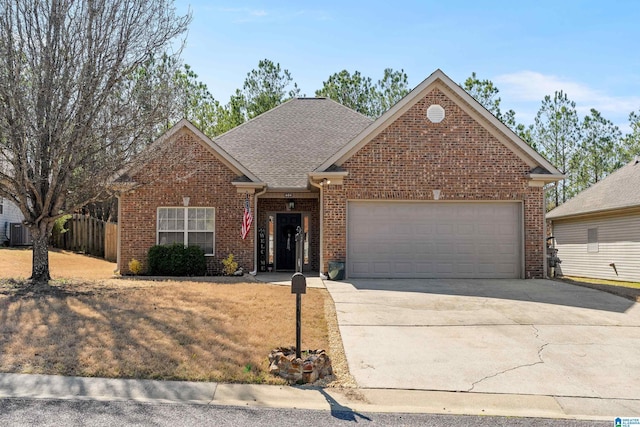 view of front facade featuring a garage, driveway, central AC, and brick siding