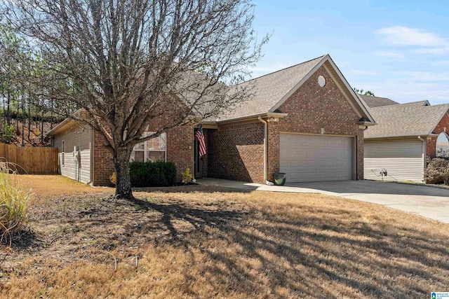 ranch-style home with brick siding, concrete driveway, an attached garage, a front yard, and fence