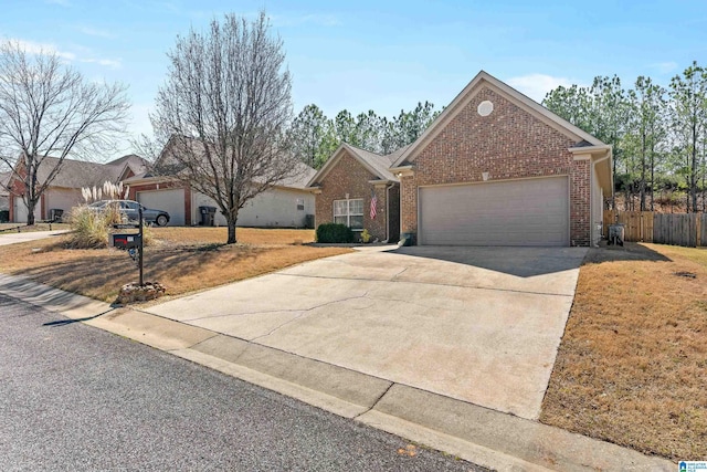 ranch-style house with driveway, brick siding, an attached garage, fence, and a front yard