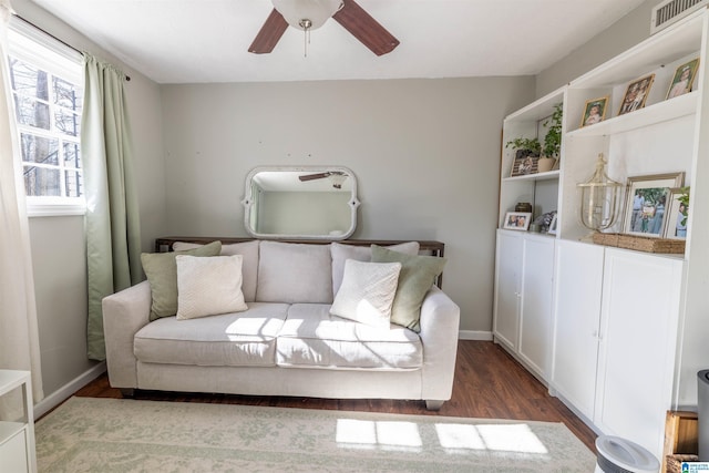 sitting room featuring dark wood-type flooring, visible vents, ceiling fan, and baseboards