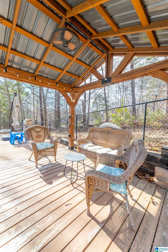 wooden deck with fence, a ceiling fan, and a gazebo