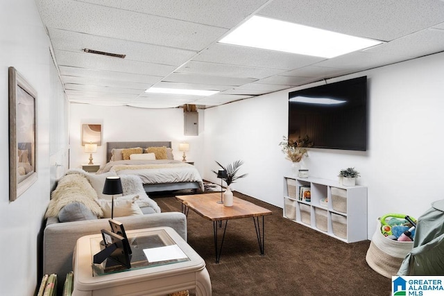 carpeted bedroom with visible vents and a drop ceiling