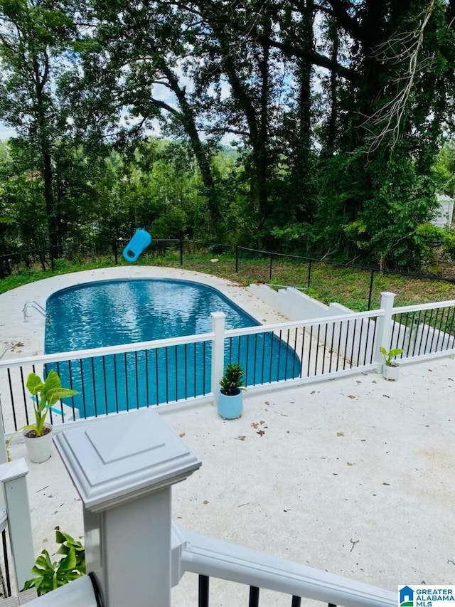 view of swimming pool with fence, a fenced in pool, and a patio