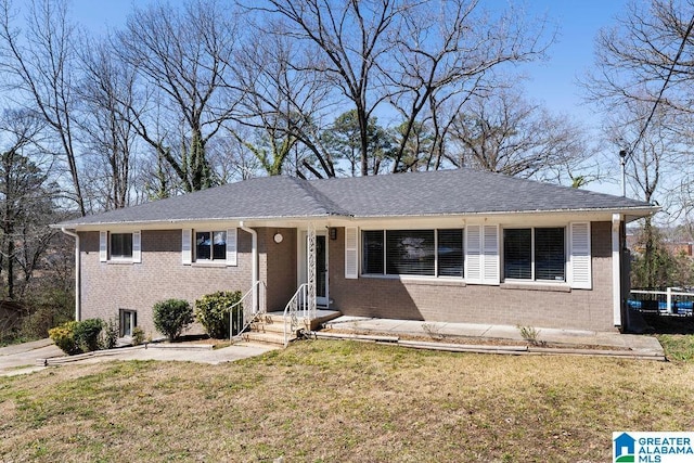 ranch-style home with brick siding and a front lawn