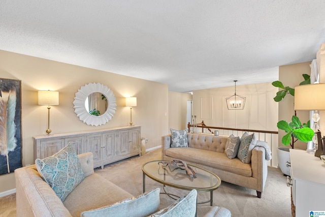 living area with light carpet, an inviting chandelier, and a textured ceiling