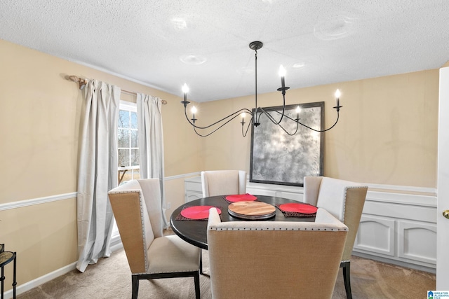 dining area with baseboards, a textured ceiling, and light colored carpet