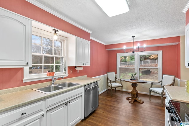 kitchen featuring light countertops, appliances with stainless steel finishes, dark wood-type flooring, white cabinetry, and a sink