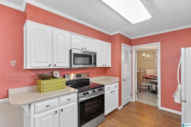 kitchen with stainless steel appliances, light countertops, and white cabinets