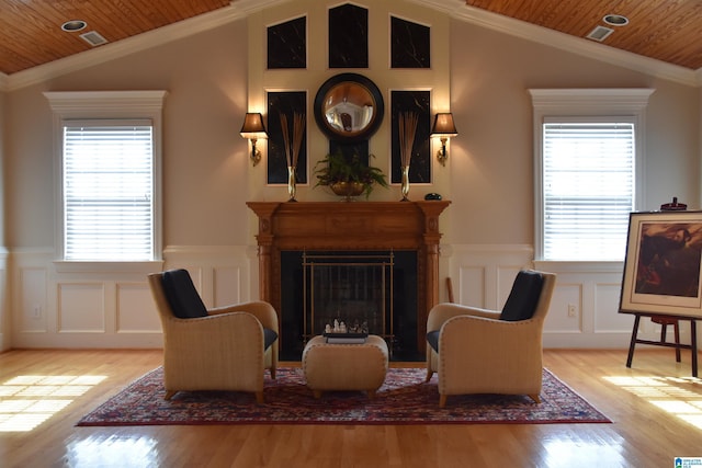 sitting room featuring wooden ceiling, vaulted ceiling, and crown molding