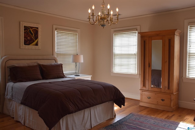 bedroom with light wood-type flooring, baseboards, and crown molding