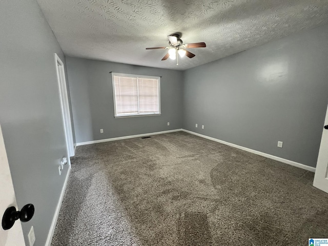 empty room with carpet floors, a textured ceiling, baseboards, and a ceiling fan