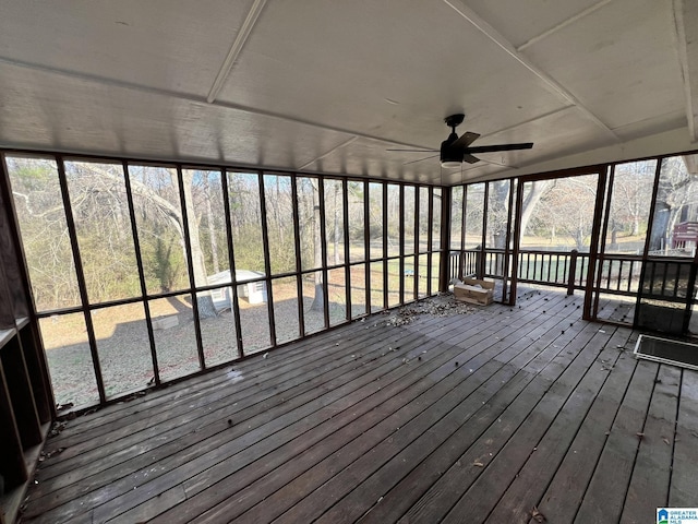 unfurnished sunroom with ceiling fan