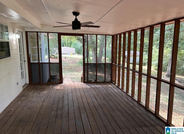 unfurnished sunroom with ceiling fan and a wealth of natural light