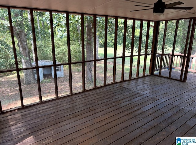 unfurnished sunroom with a ceiling fan