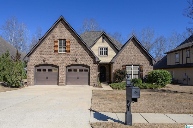 view of front of property with a garage, concrete driveway, and brick siding