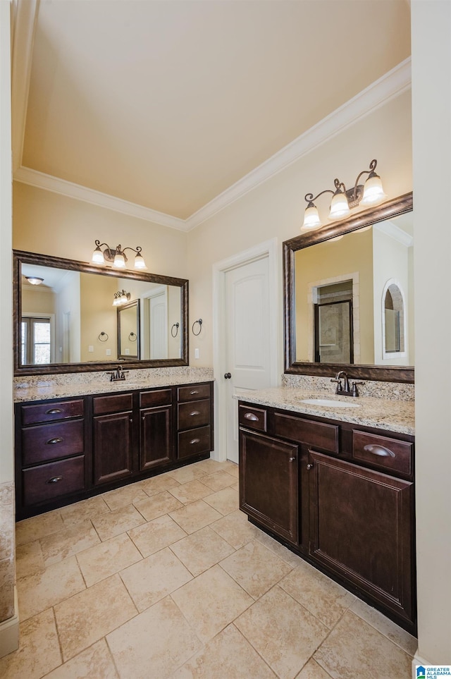 bathroom with ornamental molding, two vanities, and a sink