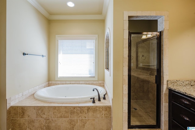 bathroom featuring ornamental molding, vanity, a shower stall, and a bath