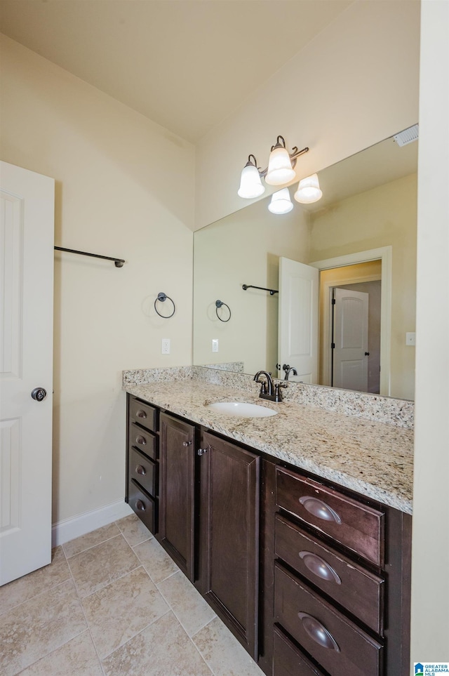 bathroom with visible vents, vanity, baseboards, and tile patterned floors