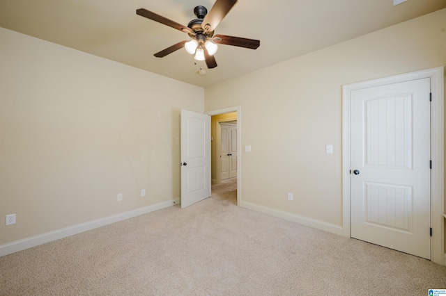 unfurnished bedroom with baseboards, ceiling fan, and light colored carpet