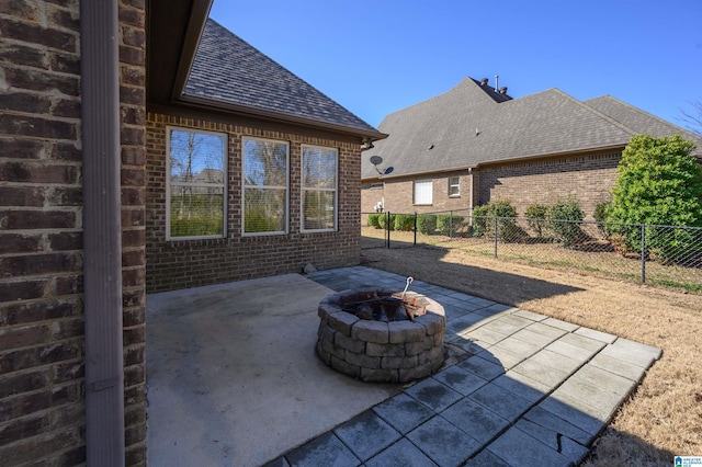 view of patio / terrace with an outdoor fire pit and fence