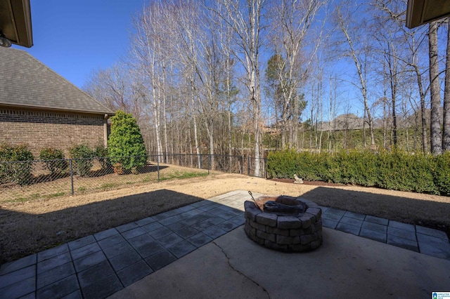 view of patio / terrace with an outdoor fire pit and fence