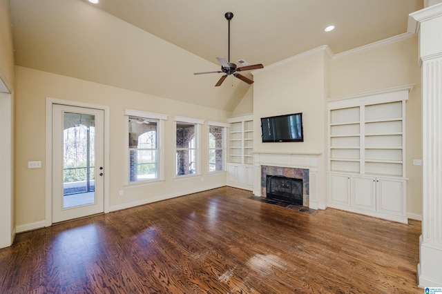 unfurnished living room with baseboards, a ceiling fan, wood finished floors, vaulted ceiling, and a fireplace