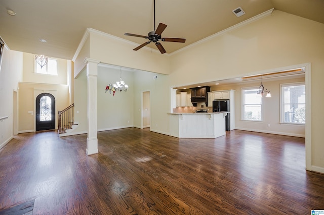 unfurnished living room featuring high vaulted ceiling, crown molding, baseboards, and dark wood-style floors