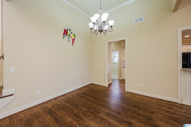 unfurnished dining area featuring baseboards, visible vents, dark wood-style floors, crown molding, and a chandelier