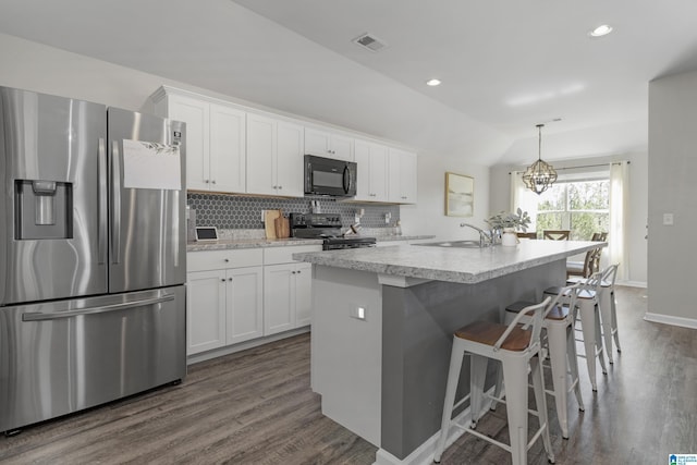 kitchen with dark wood-style flooring, visible vents, decorative backsplash, a sink, and black appliances