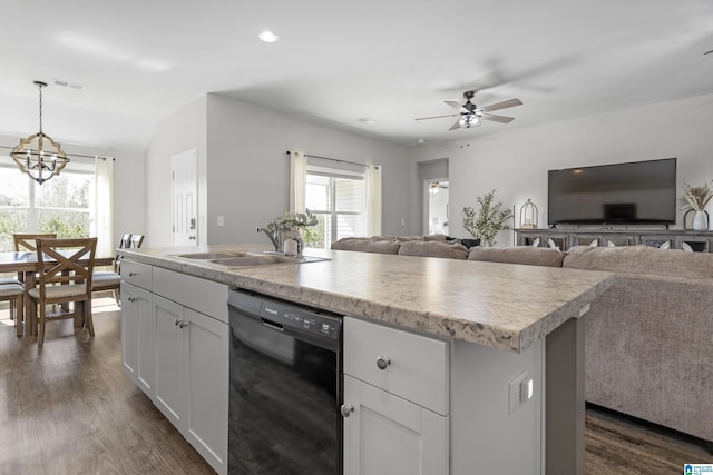 kitchen featuring visible vents, dishwasher, dark wood-style flooring, light countertops, and a sink