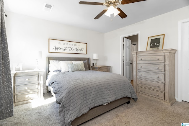 carpeted bedroom with ceiling fan and visible vents