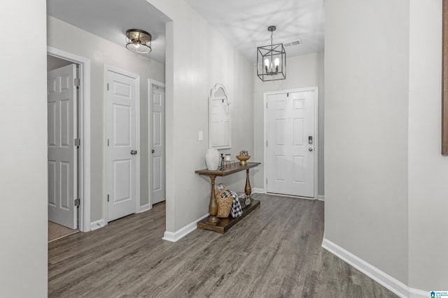 entrance foyer featuring wood finished floors, visible vents, and baseboards