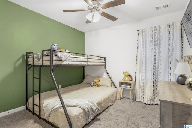 bedroom with carpet floors, visible vents, baseboards, and a ceiling fan