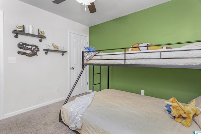 carpeted bedroom with a ceiling fan and baseboards