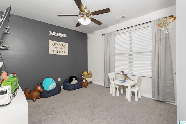 rec room featuring carpet floors, baseboards, visible vents, and a ceiling fan