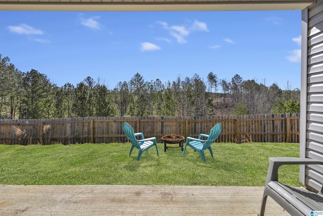 view of yard with fence and a fire pit