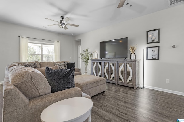 living area featuring dark wood-type flooring, visible vents, ceiling fan, and baseboards