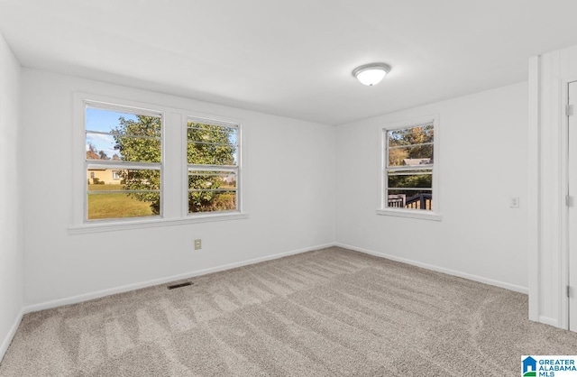 unfurnished bedroom with carpet floors, baseboards, and visible vents