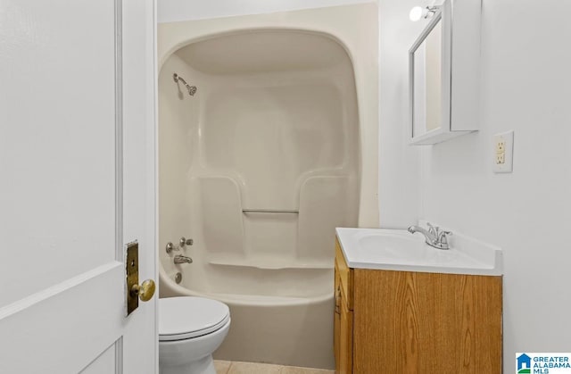 bathroom with tub / shower combination, vanity, and toilet