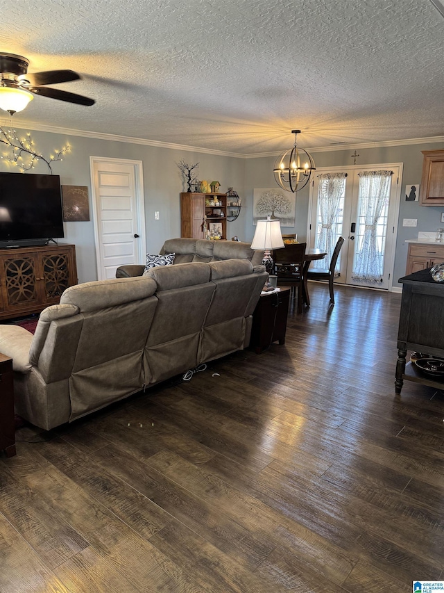 living room featuring a textured ceiling, ceiling fan with notable chandelier, dark wood finished floors, and crown molding