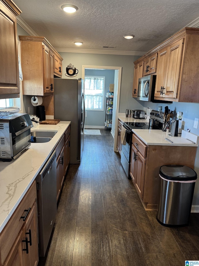 kitchen featuring appliances with stainless steel finishes, dark wood-style flooring, crown molding, and a sink