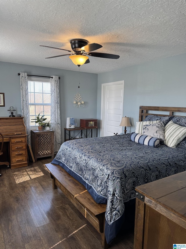 bedroom with a textured ceiling, a ceiling fan, and wood finished floors