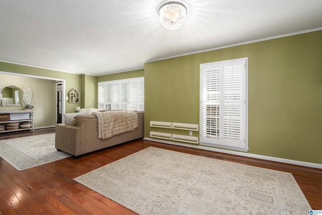 living area with dark wood-style floors, baseboards, a textured ceiling, and ornamental molding