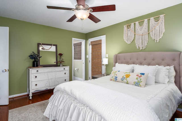 bedroom with a ceiling fan, baseboards, and wood finished floors