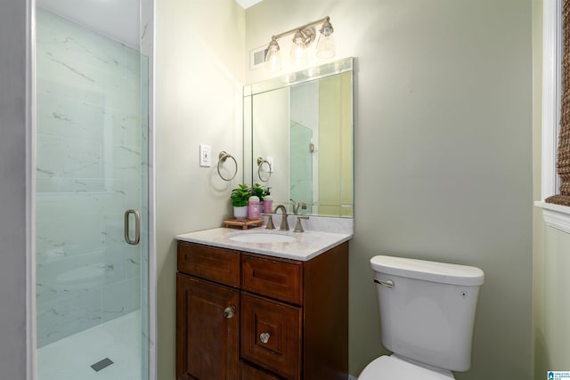 full bathroom featuring toilet, a marble finish shower, visible vents, and vanity