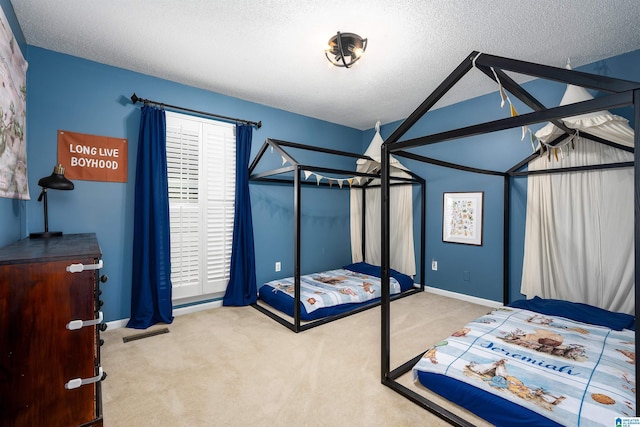 bedroom featuring a textured ceiling, lofted ceiling, carpet flooring, visible vents, and baseboards