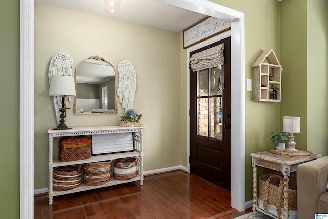 foyer with wood finished floors and baseboards